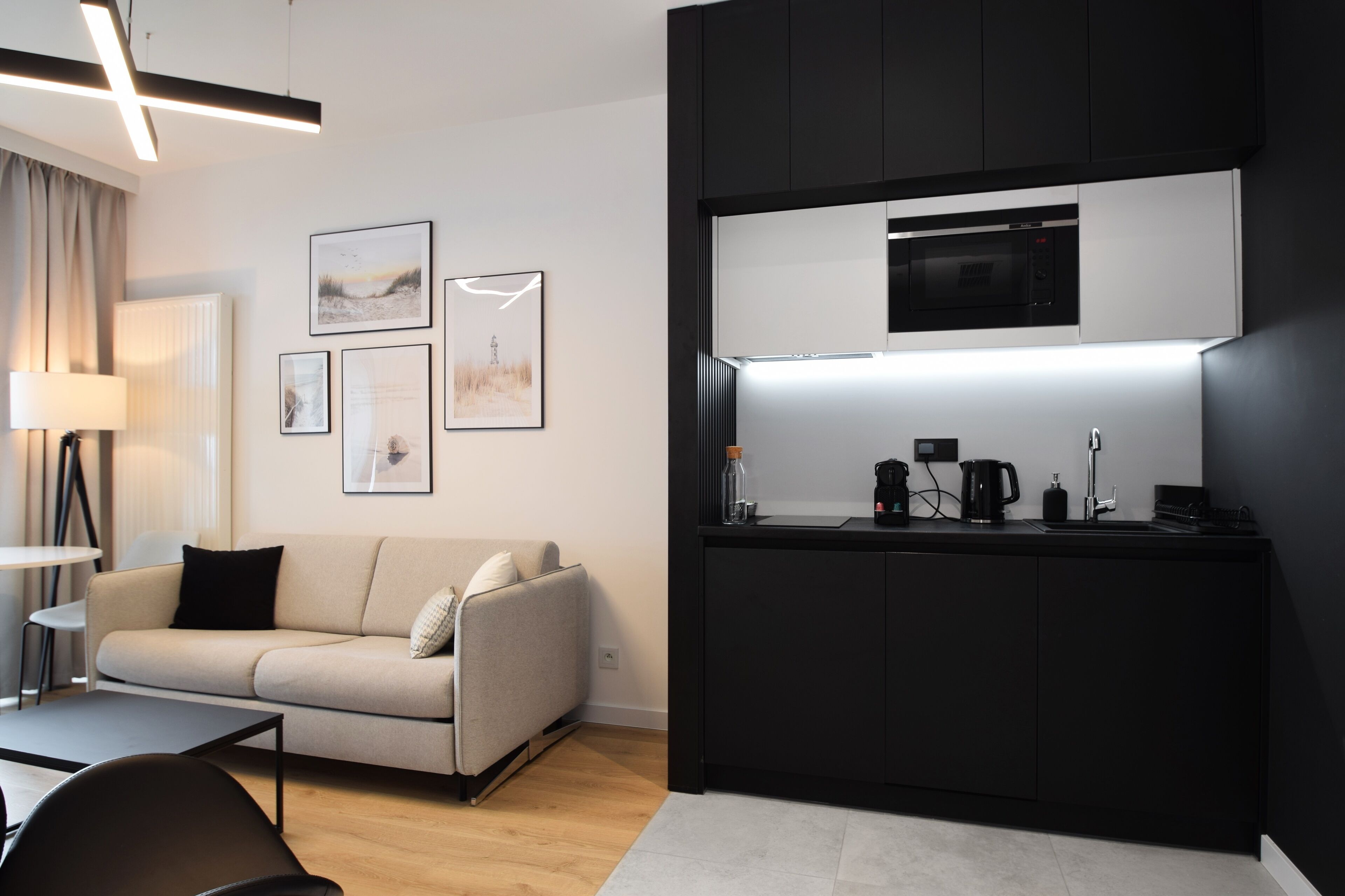 A modern kitchen with a built-in microwave, a coffee maker, and a sink.