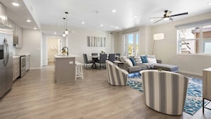 A modern living space with a kitchen, dining area, and seating area. - Primo Lagoon Retreat: Desert Color Lagoon + Beaches (St. George)