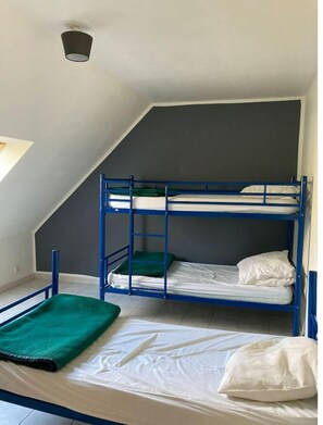Cozy retreat with a bunk bed setup, featuring a single window and a simple design.