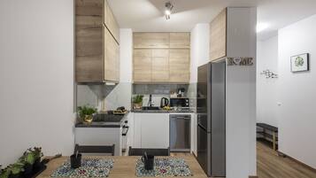 Comfort Apartment | Private kitchen | Full-size fridge, microwave, oven, stovetop