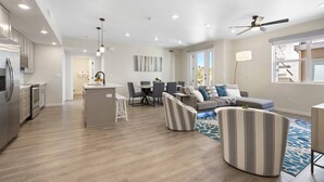 A modern living space with a kitchen, dining area, and seating area.