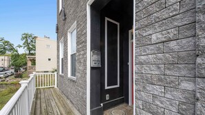 A wooden deck with a mailbox and a door leading to a stone building. - Near UC + Cincinnati Zoo 3BR Sleeps 10 (Cincinnati)