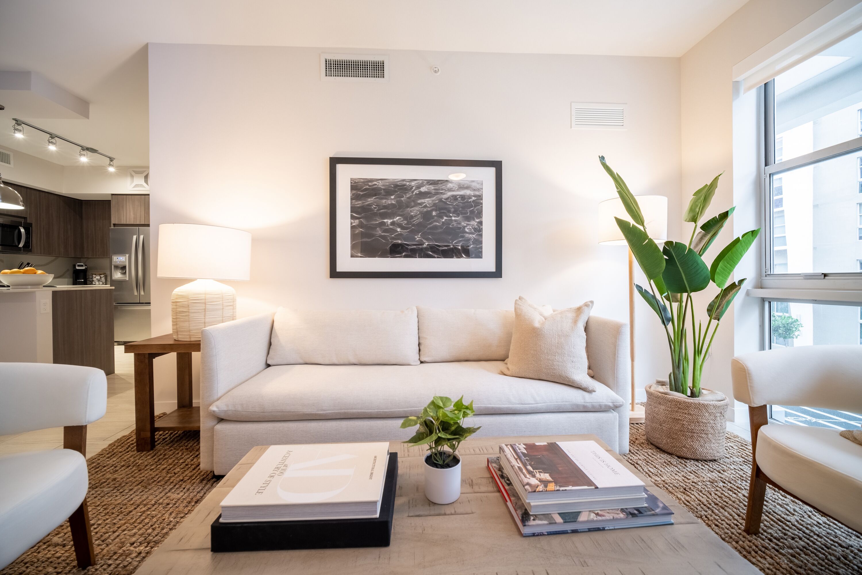 A modern living room with a sofa, coffee table, and a framed picture on the wall.