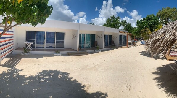 A modern building with large windows and a sandy ground. - La Isla Bonita (Punta Rucia)