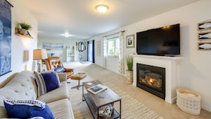 A living room with a fireplace, a television, and a sofa.
