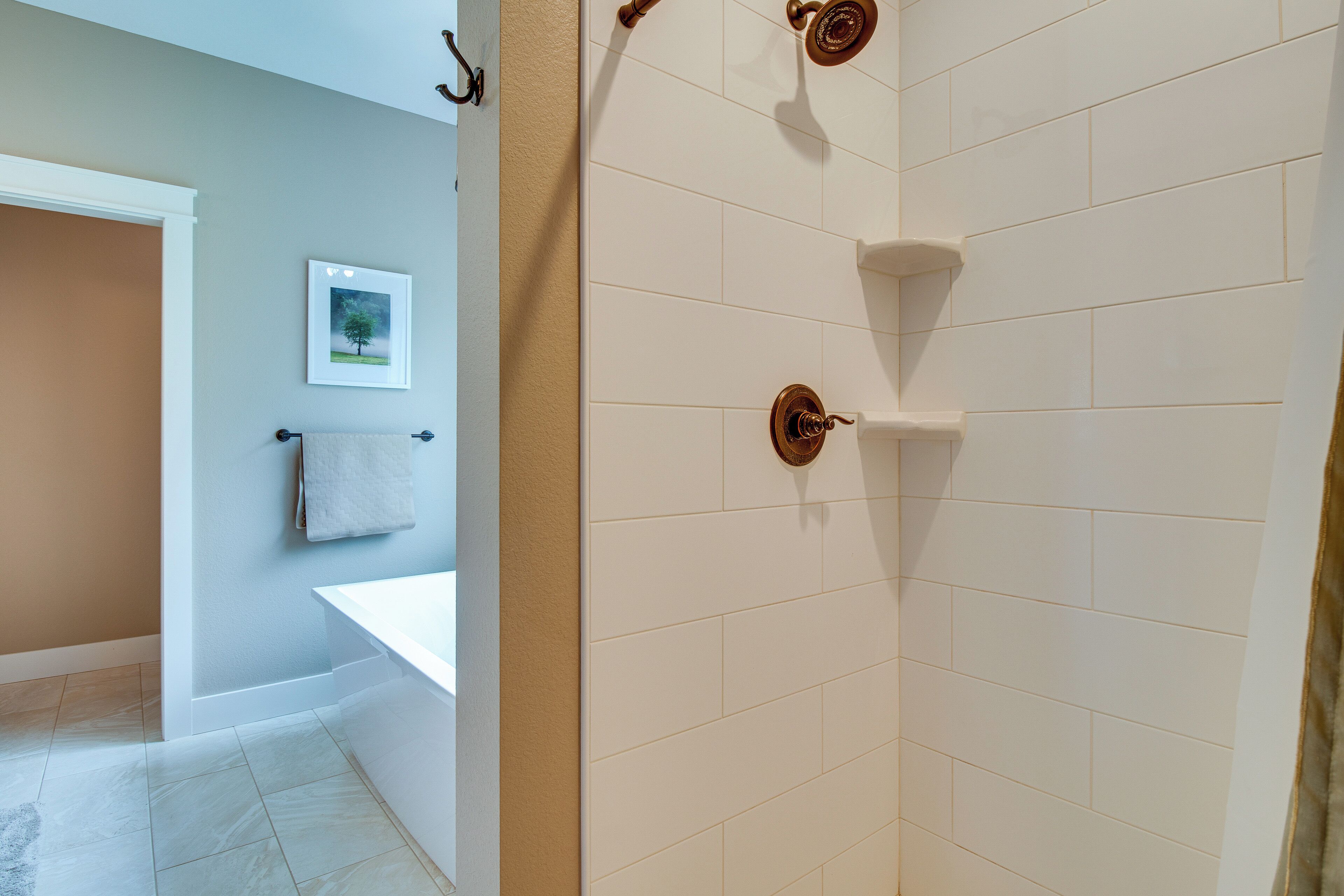 A bathroom with a bathtub, a shower, and a toilet.