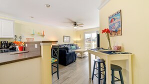 A kitchen with a dining area, a ceiling fan, and a view of the outside. - Oak Island Vacation Rental ~ 1 Block to Beach! (Oak Island)