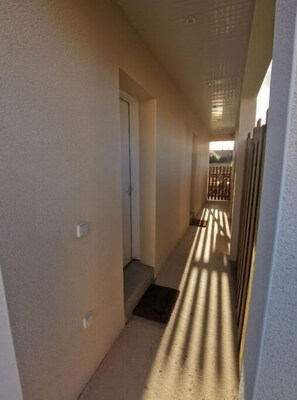Leading to an outdoor area, this corridor offers a simple, functional design.