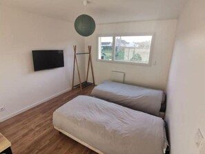 Enjoy a peaceful stay in this cozy room with a single bed, large window, and mounted TV.