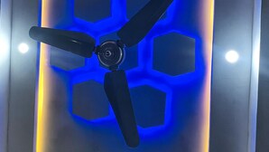 A ceiling fan with a blue light and a hexagonal pattern. - Hotel 11 (Islamabad)