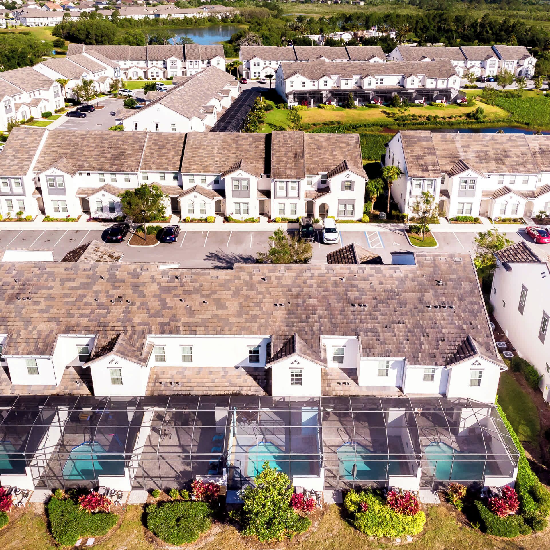 A residential area with multiple two-story houses, a swimming pool, and a parking lot.