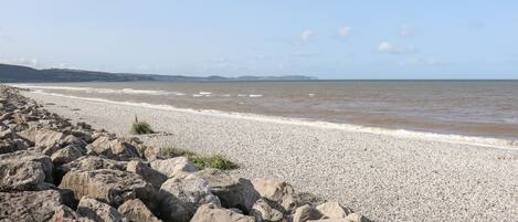 A rocky beach with a pebble shore and a calm sea.