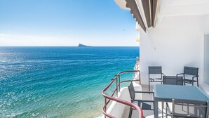 A balcony with a view of the ocean, a table, and chairs. - Lux Center 5-C Deluxe Beach Apartment-Old Town (Benidorm)