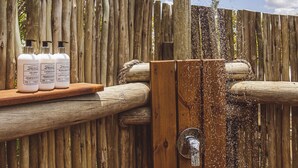 A wooden outdoor shower with a wooden fence in the background. - Cape Vulture Lodge (Hoedspruit)