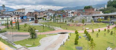 A park with pathways, benches, and a statue.