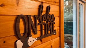 A wooden wall with a sign that reads "ON lake time."