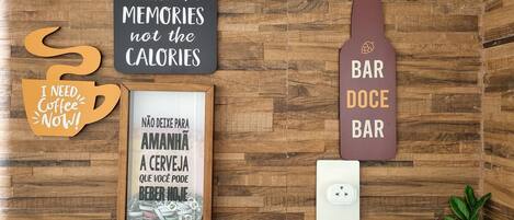 A wooden wall with various signs and a framed picture.