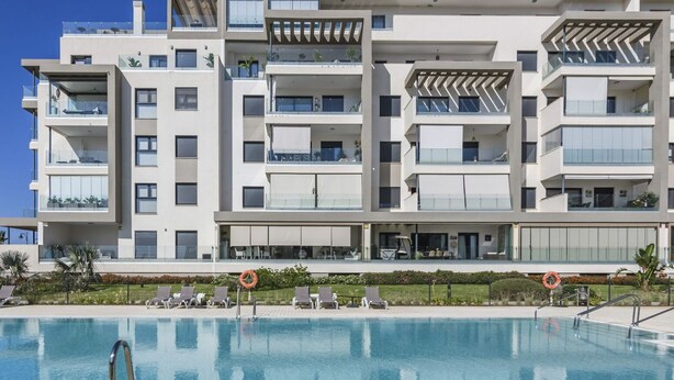A modern multi-story hotel with a swimming pool, balconies, and outdoor seating areas. - Los Flamencos 4004 - Two Bedroom Apartment, Sleeps 5 (Punta del moral)