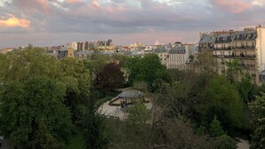 A cityscape with a park area featuring a gazebo, surrounded by buildings and trees. - Le Marais, rue de Bretagne Square du Temple - Elie Wiesel (Paris)