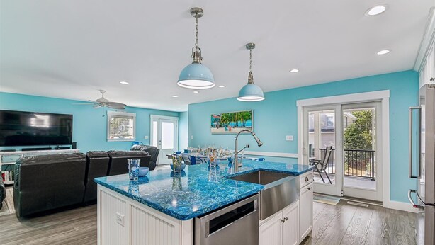 A modern kitchen with a blue marble countertop, stainless steel appliances, and pendant lighting. - 7BR Pet-Friendly Home w/ EV Charger & Room for 18+ Guests (Bethany Beach)