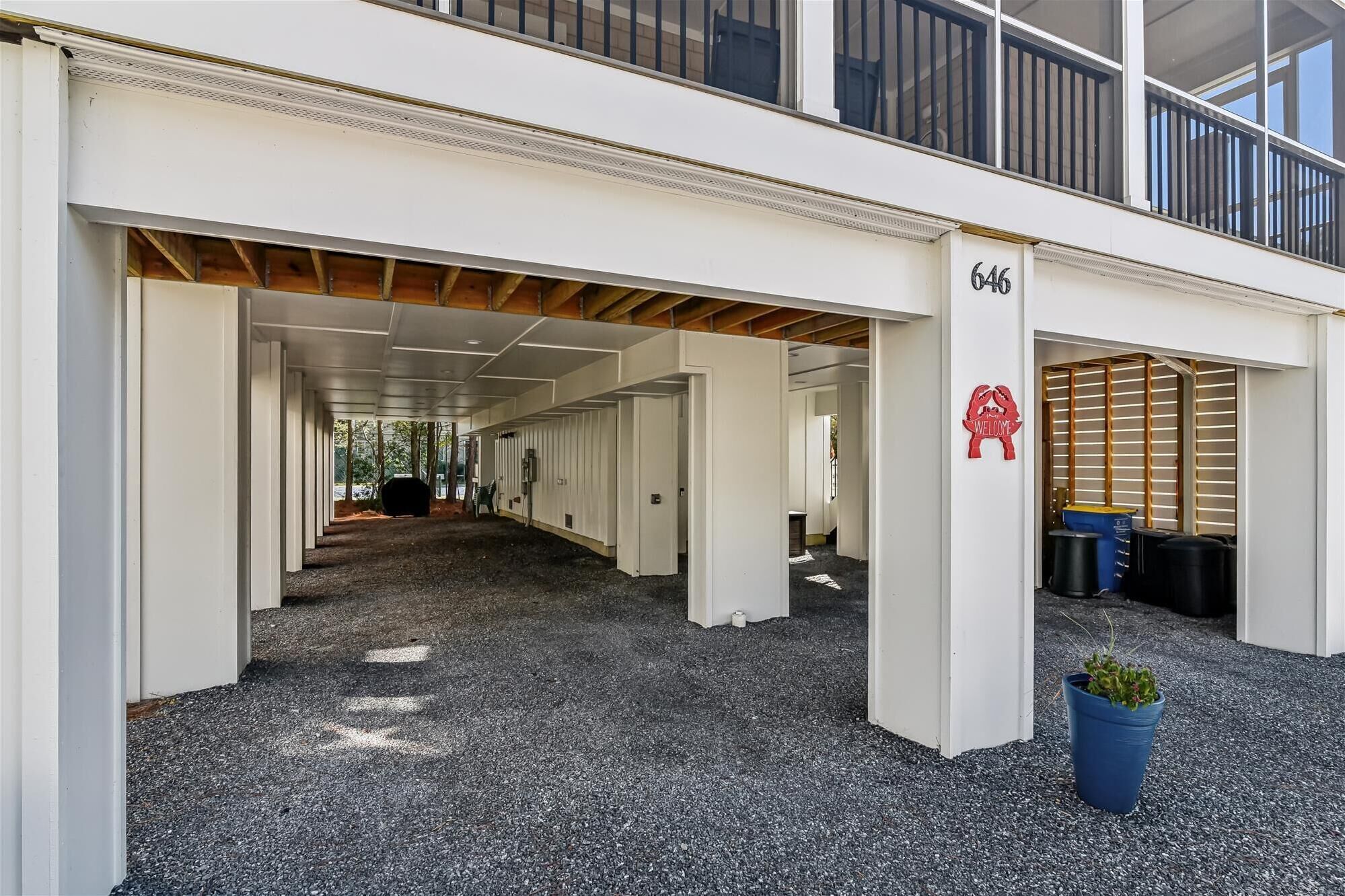 A building with a covered outdoor area, a sign with the number 646, and a welcome sign.