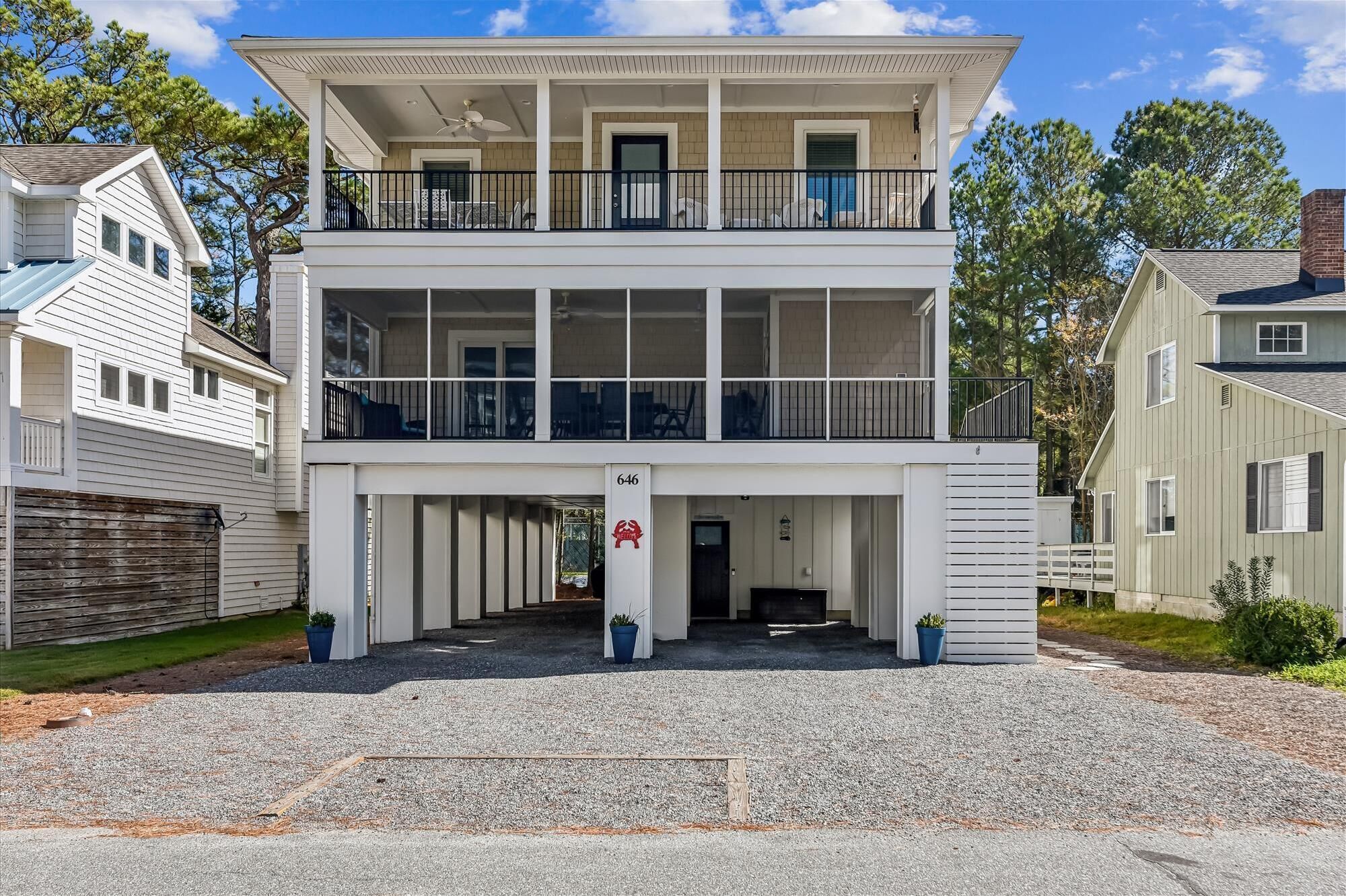A two-story house with a balcony on the upper floor, a garage entrance, and a number 646 sign.