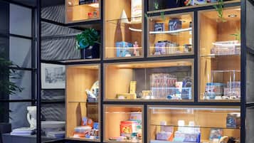 A display of various products in a store with multiple shelves and glass cases.