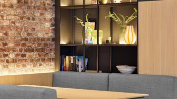 A modern interior with a brick wall, a bookshelf, and a seating area.