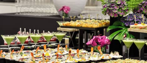 A buffet with various food items and drinks.