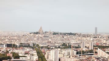 A cityscape with a prominent tower in the background, dense urban buildings, and a clear view of the city layout.