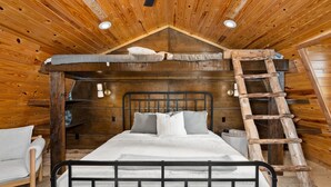 A wooden cabin bedroom with a loft bed, a ladder, and a small table. - The Hendo - Cabin #2- Intimate Family Getaway (Henderson)