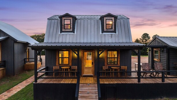 A rustic cabin with a wooden deck, two porches, and a central door leading to a cozy interior. - The Hendo - Cabin #2- Intimate Family Getaway (Henderson)