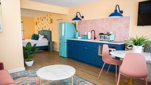 A compact living space with a bed, kitchenette, dining area, and a small seating area. - Sunburst Inn The Combo - Room 11 & 8 (Indian Shores)