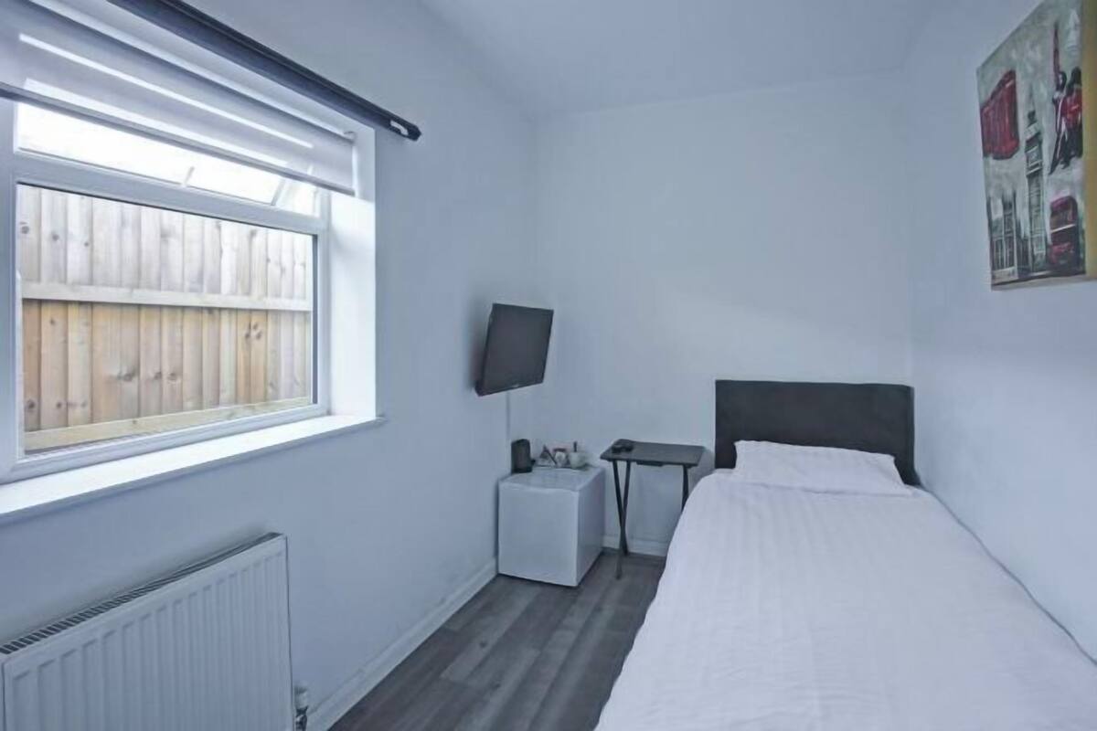 Desk, iron/ironing board, bed sheets