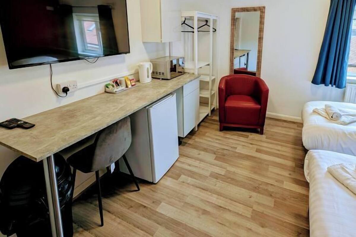 Desk, iron/ironing board, bed sheets