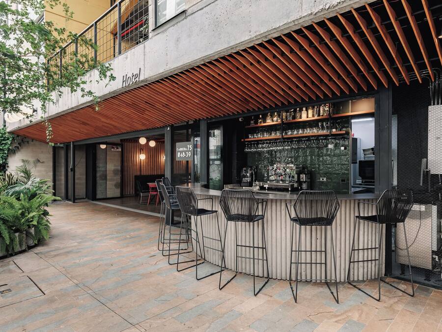 A bar area with a counter, stools, and a view of the street.