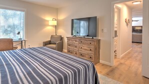 A bedroom with a bed, a desk, a chair, a dresser, and a television. - Newly updated in Forest Gardens (Hilton Head Island)