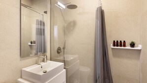 A modern bathroom with a glass-enclosed shower, a white sink, and a mirror. - Kerameikou25 small ·  Excellent value for money in (Athens)