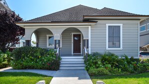 A single-story house with a front porch, a number '844' sign, and a well-maintained lawn.