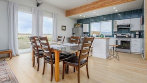 A modern kitchen with white cabinets, a built-in oven, and a microwave. - Newly renovated Barnhouse on 13 acres brings you a modern feel to your retreat.  (Grand Junction)