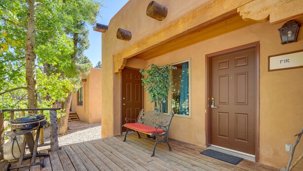 A wooden deck with a grill, a bench, and a door labeled "FIR". - Charming Amalia Retreat w/ Fireplace & Grill! (Amalia)