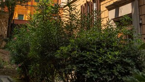 A building with multiple windows and balconies, surrounded by greenery. - Elegant and spacious suite in upscale setting within walking distance of Villa Borghese. (Roma)