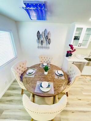 Enjoy meals in this stylish dining area with a round table and tufted chairs.