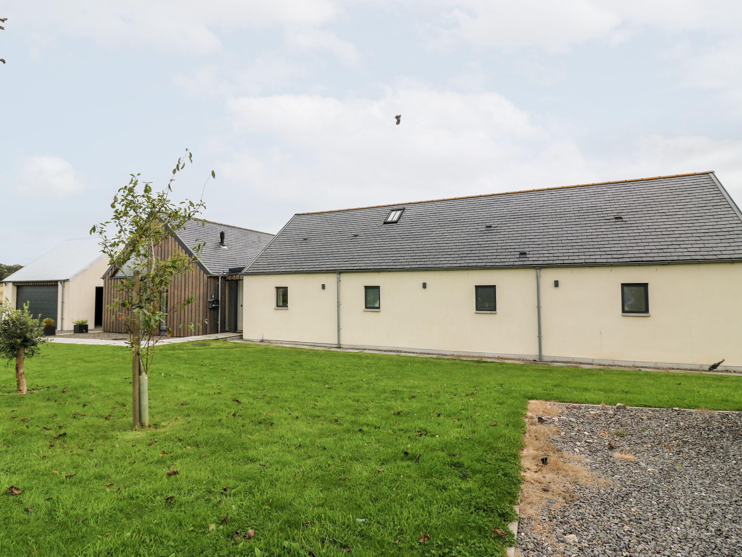 A modern building with a flat roof and multiple windows.
