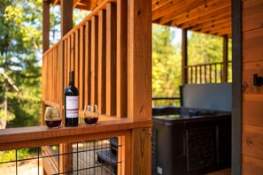 Pour a glass at the deck rail as the evening cools off — the wine is your call, the hot tub is steps away. - Top 5% · Pet Friendly · Hot Tub · Arcade · Views (Sevierville)