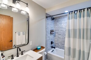 A bathroom with a large mirror, a sink, a toilet, and a shower area with a curtain. - 6 Mi to Winter Park: Mtn-View Condo w/ Balcony! (Fraser)