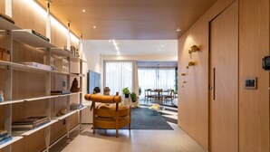 A modern interior with wooden shelving, a dining area, and a view through a large window. - 10 Minutes From Ipanema Beach Vm201 (Rio de Janeiro)