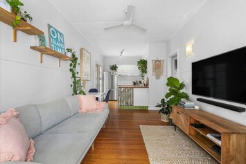 The main living area is open to the kitchen and dining space and equipped with smart TV, ceiling fan, comfortable 3-seater lounge and plenty of greenery.