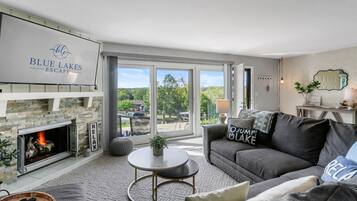 Smart TV, fireplace, books, computer monitors