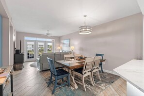 A dining area with a table, chairs, and a ceiling fan. - Atlantis 205B - Beachers Landing - Renovated (St. Augustine Beach)